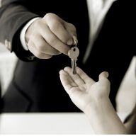 a man handing over a key